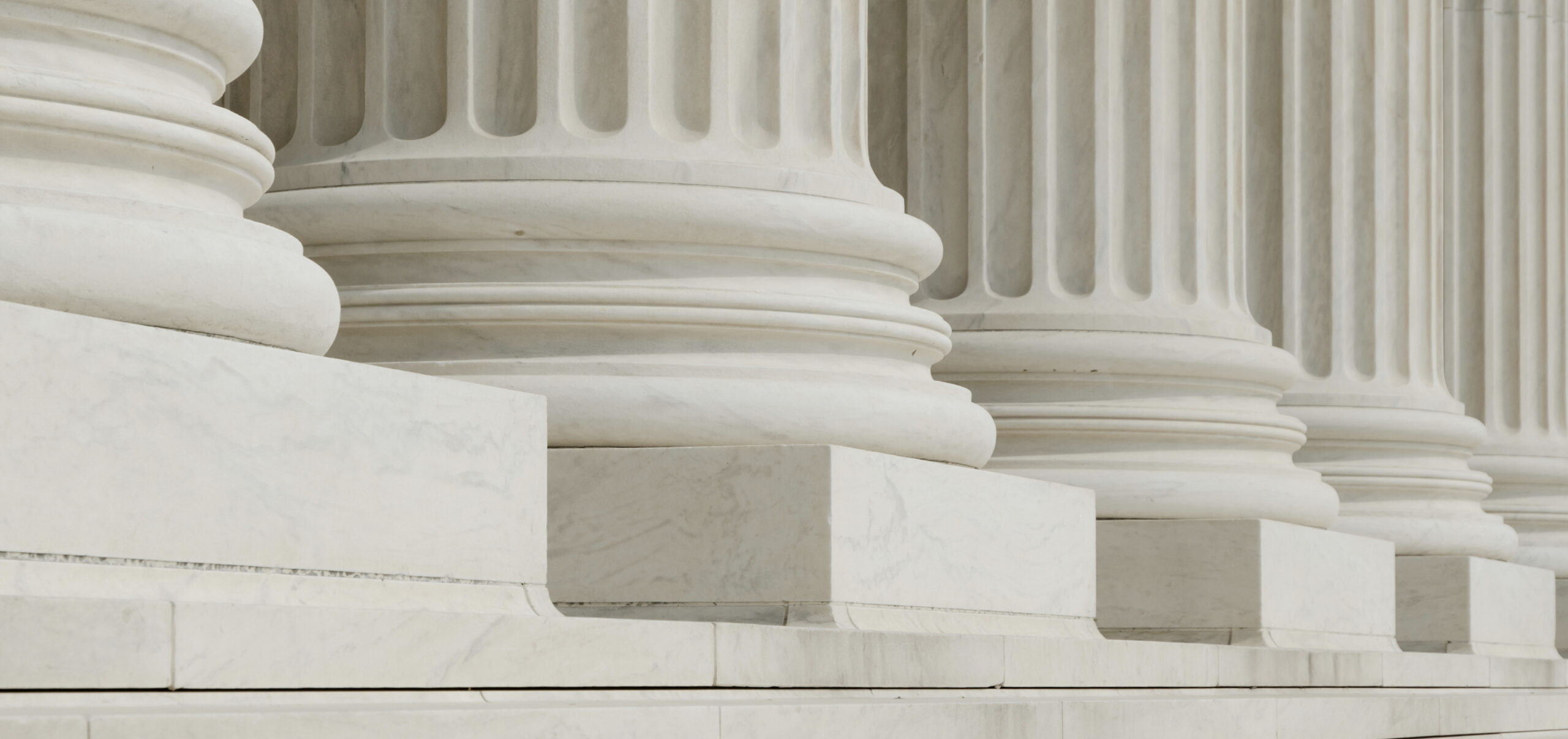 White marble columns such as what you would see outside of a courthouse or government building.